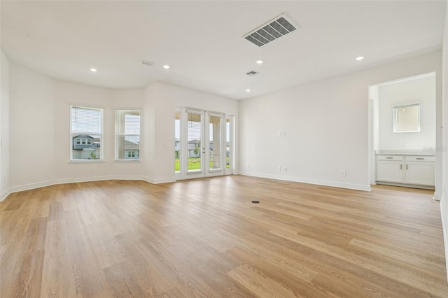 16354 Silver Grove Blvd, Winter Garden, FL 34787 - unfurnished living room with plenty of natural light, light wood-style flooring, baseboards, and recessed lighting