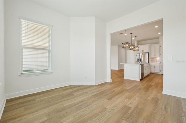 16354 Silver Grove Blvd, Winter Garden, FL 34787 - empty room with light wood-type flooring, a chandelier, baseboards, and recessed lighting