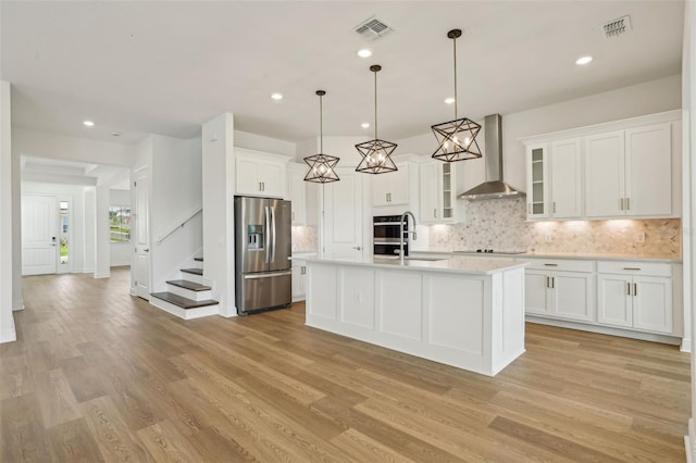 16354 Silver Grove Blvd, Winter Garden, FL 34787 - kitchen featuring stainless steel appliances, wall chimney range hood, light countertops, light wood-style flooring, and recessed lighting