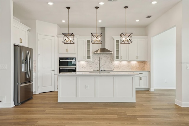 16354 Silver Grove Blvd, Winter Garden, FL 34787 - kitchen featuring stainless steel fridge, wall chimney range hood, light countertops, white cabinets, and recessed lighting