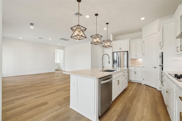 16354 Silver Grove Blvd, Winter Garden, FL 34787 - kitchen featuring a sink, appliances with stainless steel finishes, light wood finished floors, light countertops, and recessed lighting