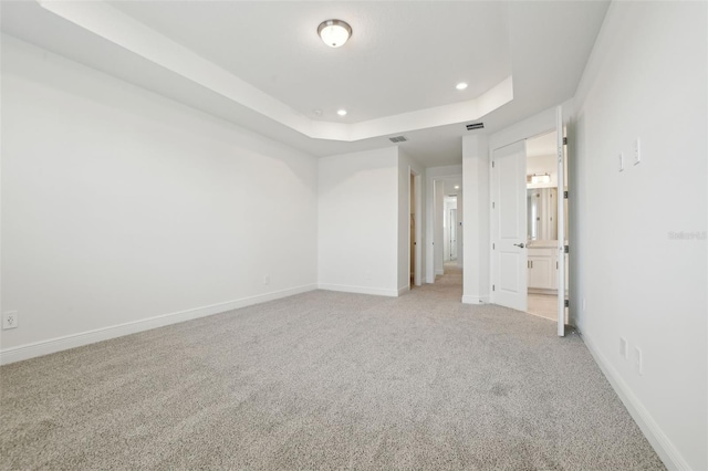 16354 Silver Grove Blvd, Winter Garden, FL 34787 - unfurnished bedroom with a tray ceiling, light carpet, recessed lighting, and baseboards