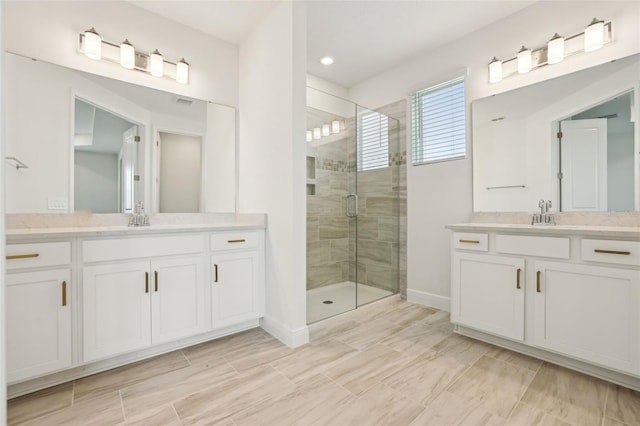 16354 Silver Grove Blvd, Winter Garden, FL 34787 - bathroom with a stall shower, baseboards, two vanities, and recessed lighting