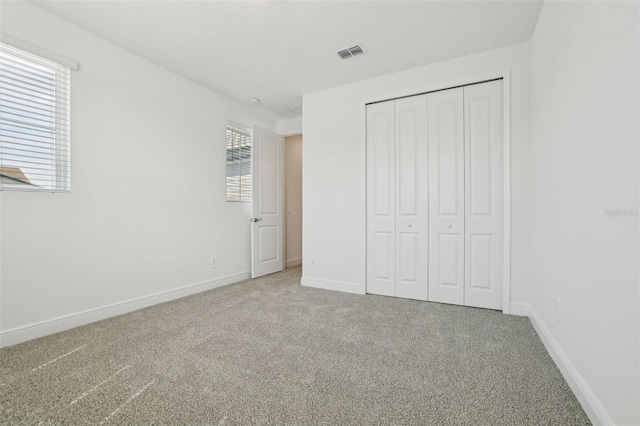 16354 Silver Grove Blvd, Winter Garden, FL 34787 - unfurnished bedroom featuring carpet floors, a closet, and baseboards