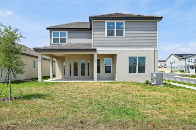 16354 Silver Grove Blvd, Winter Garden, FL 34787 - back of house featuring central air condition unit, a lawn, stucco siding, and a patio area