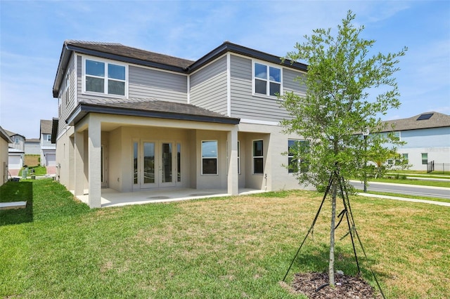16354 Silver Grove Blvd, Winter Garden, FL 34787 - back of house with stucco siding, a patio, a yard, and french doors