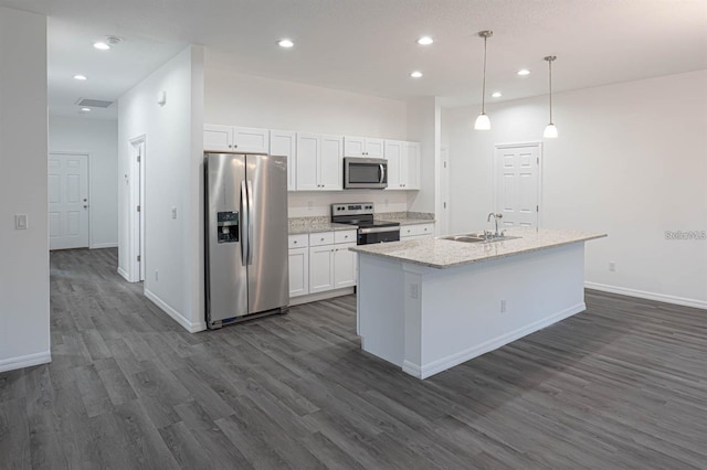 kitchen with dark wood finished floors, recessed lighting, stainless steel appliances, white cabinetry, and a sink