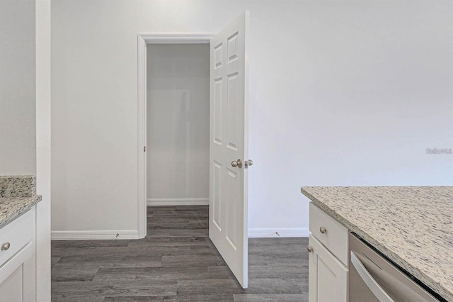 interior space with vanity, baseboards, and wood finished floors