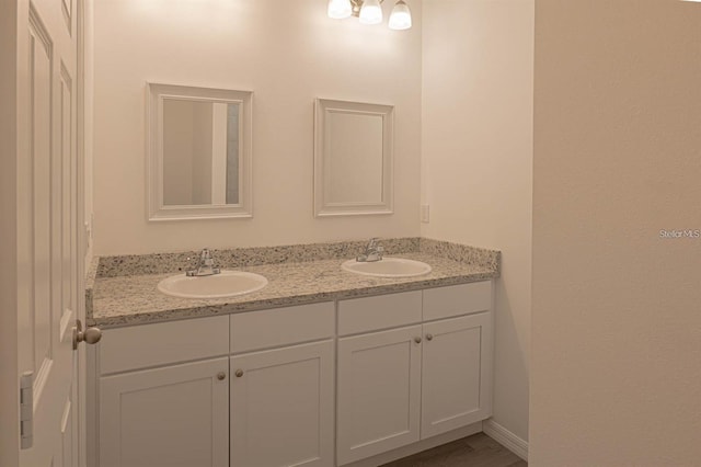 bathroom with a sink and double vanity