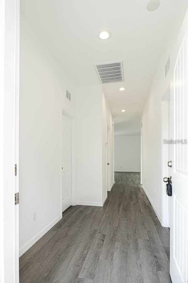 corridor featuring visible vents, recessed lighting, and wood finished floors