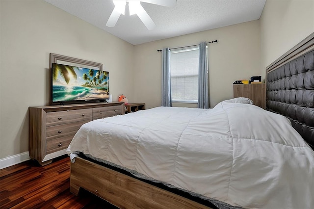 bedroom with a textured ceiling, dark wood-style floors, baseboards, and ceiling fan