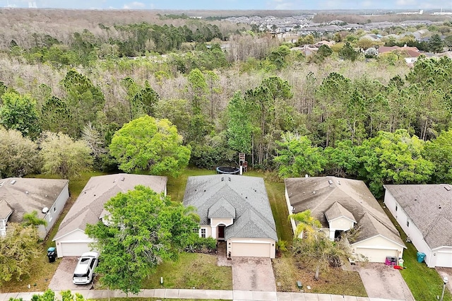 birds eye view of property with a view of trees