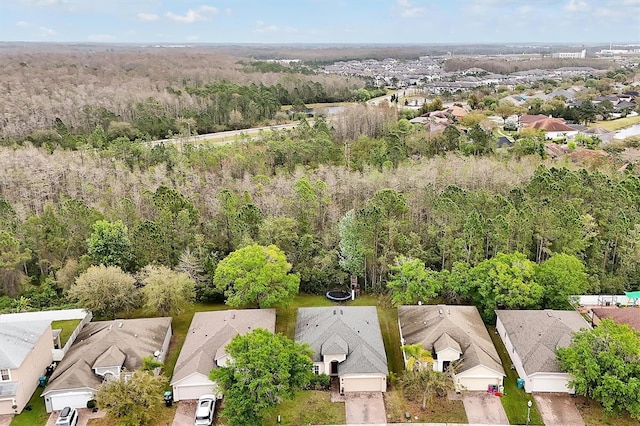 bird's eye view with a wooded view and a residential view