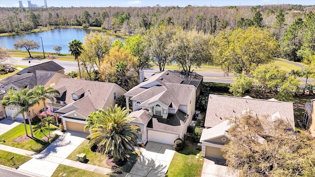 bird's eye view with a forest view, a water view, and a residential view