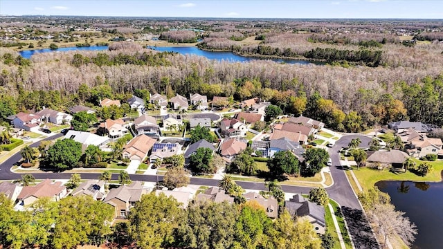 birds eye view of property featuring a residential view, a forest view, and a water view