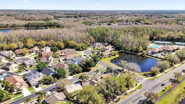 bird's eye view with a view of trees, a water view, and a residential view