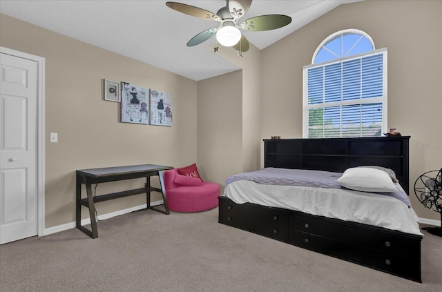 carpeted bedroom featuring baseboards, multiple windows, a ceiling fan, and vaulted ceiling