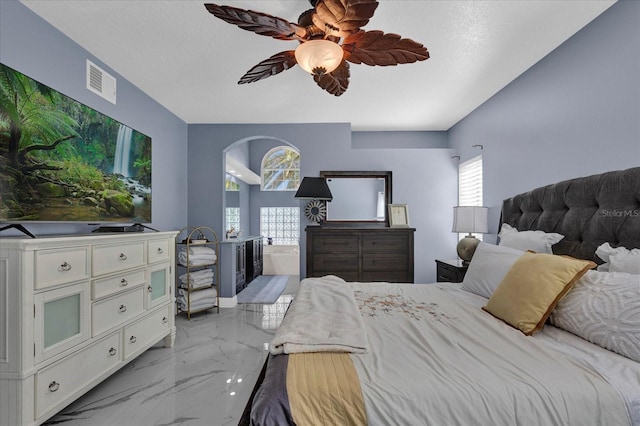 bedroom with visible vents, multiple windows, arched walkways, and marble finish floor