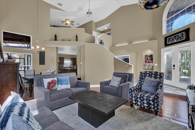 living room with wood finished floors, french doors, visible vents, and high vaulted ceiling