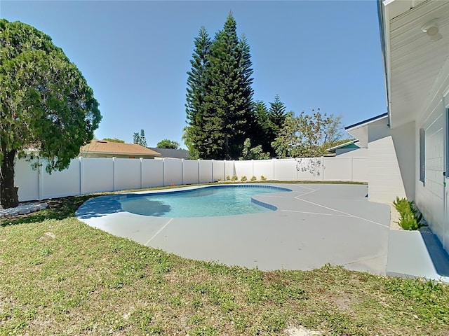 view of swimming pool with a fenced in pool, a lawn, and a fenced backyard