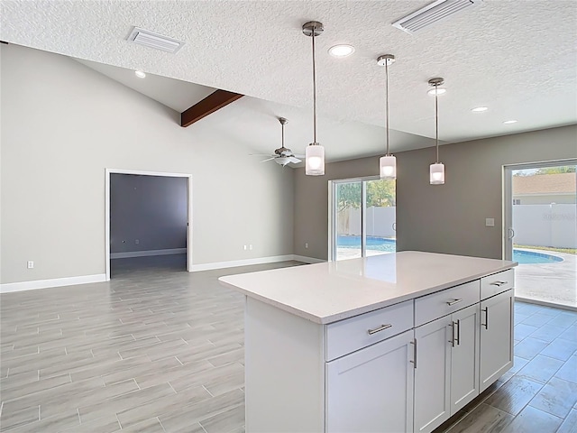 kitchen with visible vents, hanging light fixtures, a ceiling fan, and light countertops