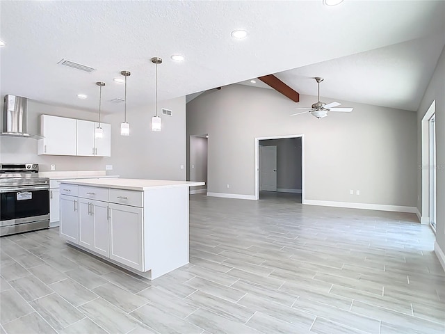 kitchen featuring visible vents, vaulted ceiling with beams, light countertops, stainless steel range with electric stovetop, and wall chimney exhaust hood