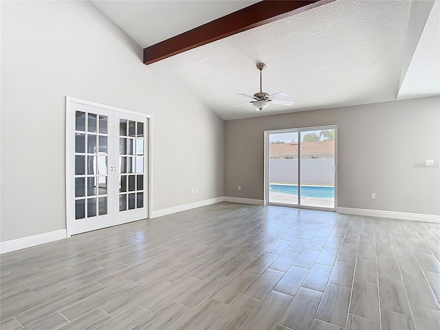 unfurnished room featuring baseboards, french doors, vaulted ceiling with beams, and ceiling fan