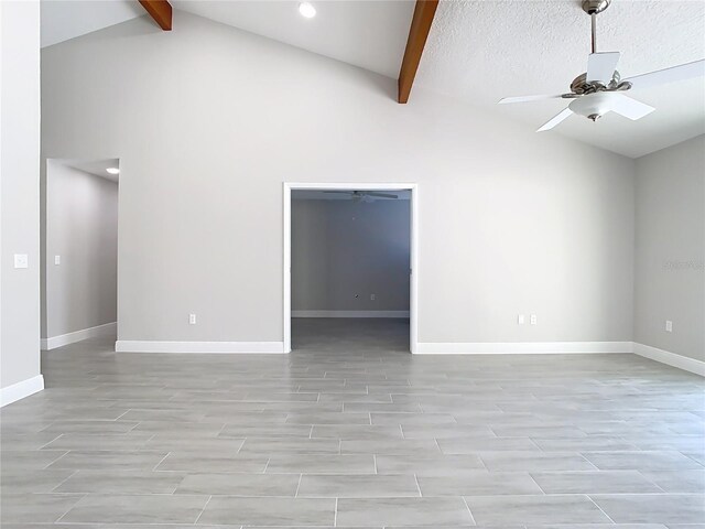 spare room with beam ceiling, baseboards, and ceiling fan