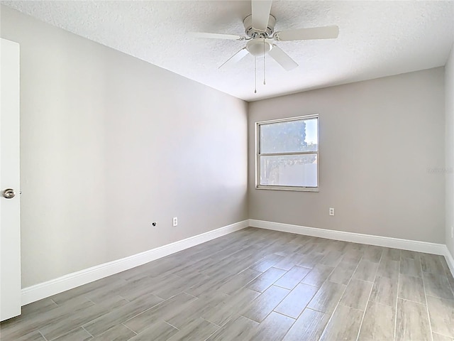 unfurnished room featuring ceiling fan, baseboards, and light wood-style floors