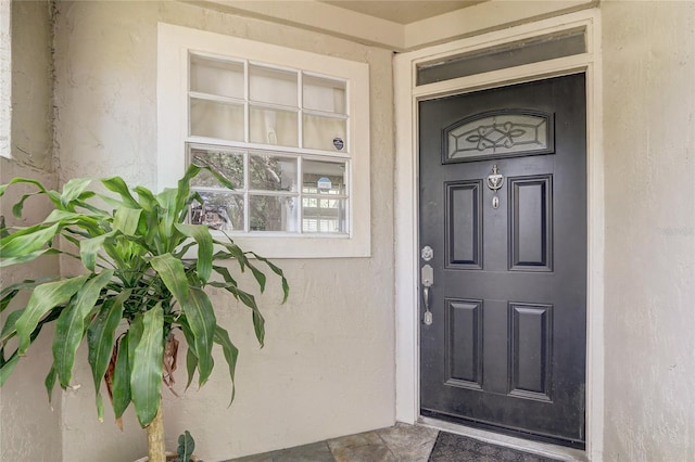 property entrance featuring stucco siding