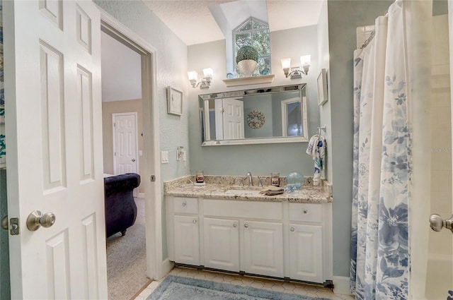 full bath featuring a shower with shower curtain, vanity, and tile patterned floors