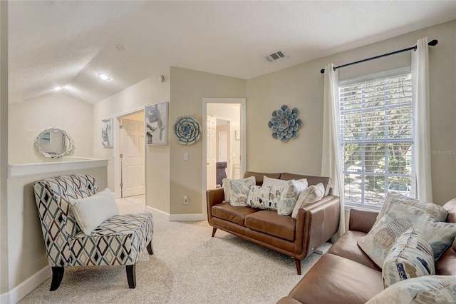 living area with light colored carpet, baseboards, and lofted ceiling