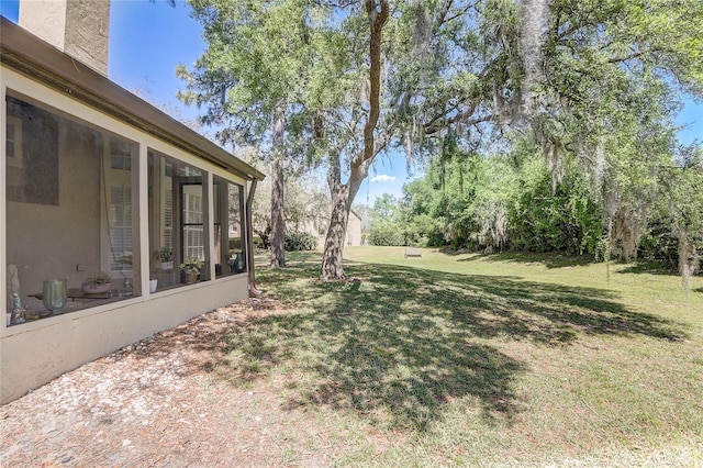 view of yard with a sunroom