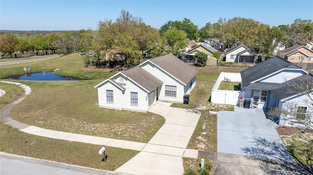 birds eye view of property with a residential view and a water view