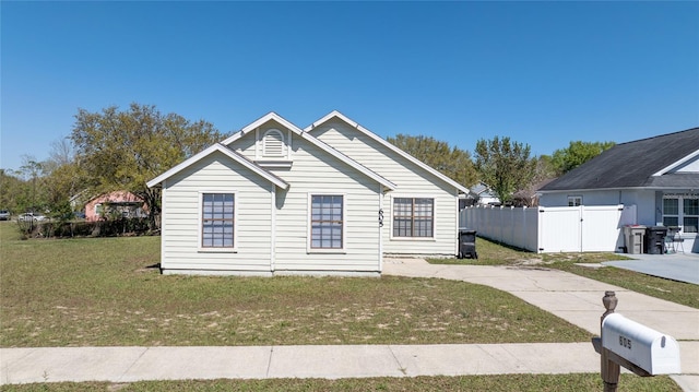 bungalow with a gate, a front yard, and fence