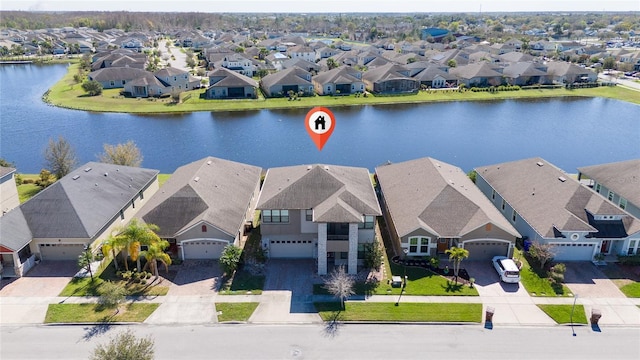 drone / aerial view featuring a residential view and a water view