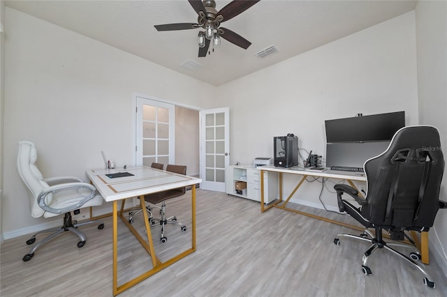 home office with visible vents, ceiling fan, french doors, and light wood finished floors