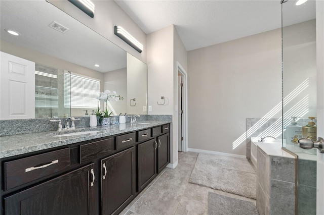 full bath with a garden tub, a stall shower, visible vents, and a sink