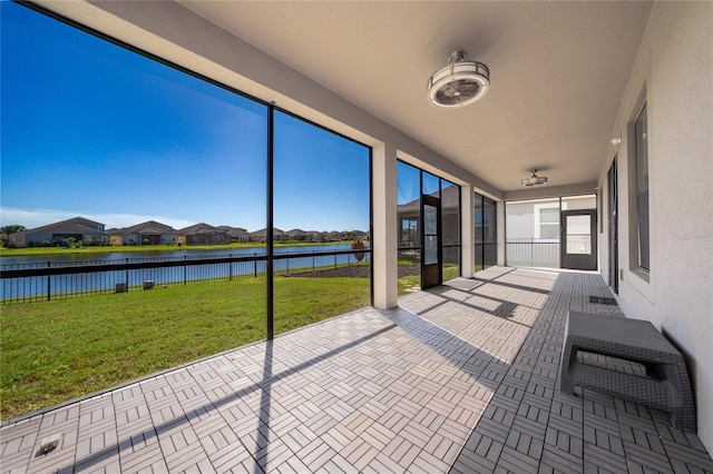 unfurnished sunroom with a water view