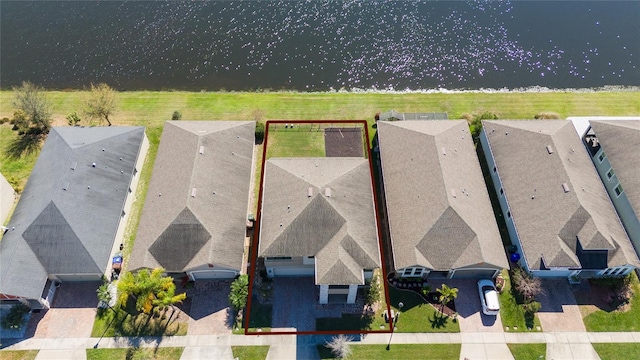 bird's eye view with a residential view and a water view