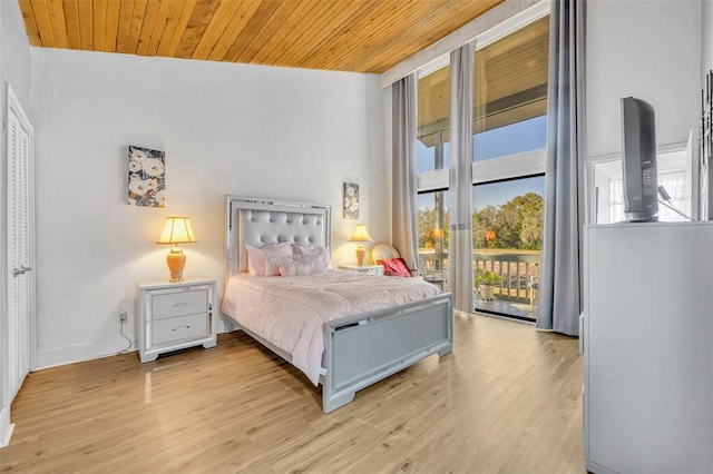 bedroom featuring light wood-style floors, wooden ceiling, and access to outside