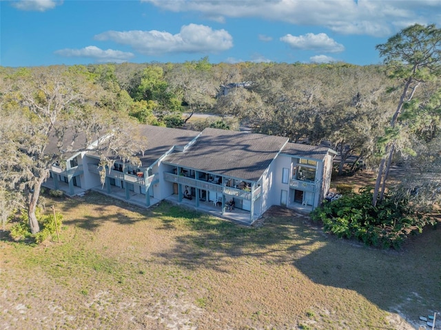 drone / aerial view featuring a view of trees