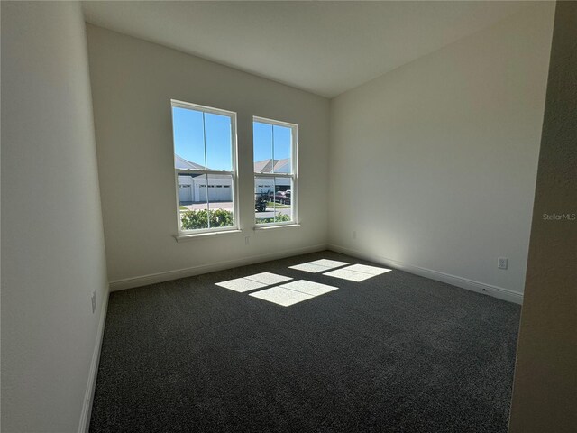 carpeted empty room with baseboards