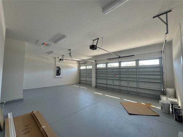 garage featuring electric panel and a garage door opener