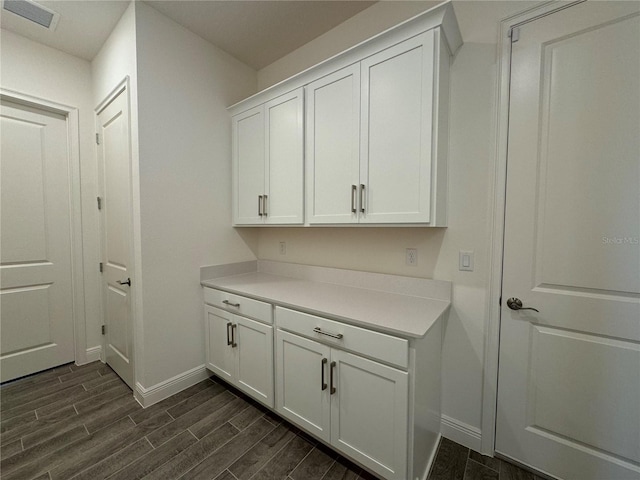 washroom featuring baseboards, visible vents, and wood tiled floor