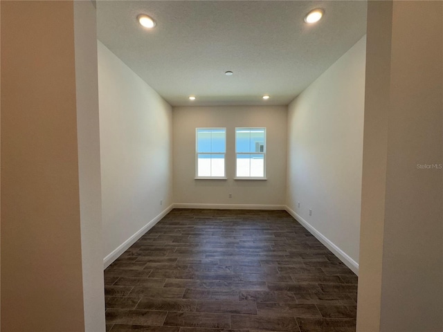 unfurnished room with recessed lighting, baseboards, and dark wood finished floors