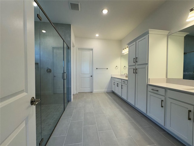 bathroom featuring visible vents, baseboards, recessed lighting, a stall shower, and vanity