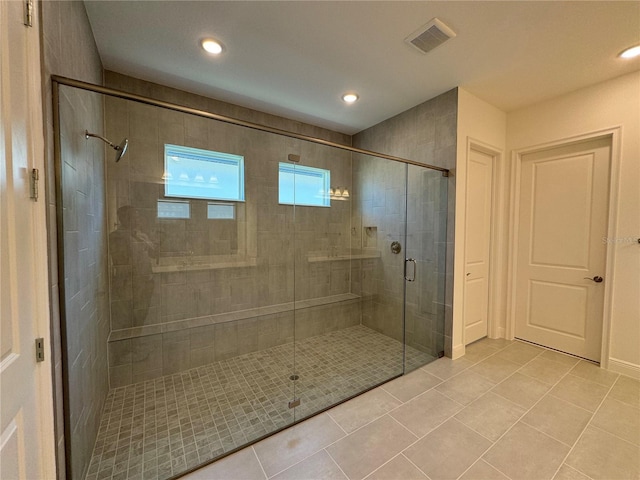 bathroom with tile patterned flooring, a shower stall, recessed lighting, and visible vents