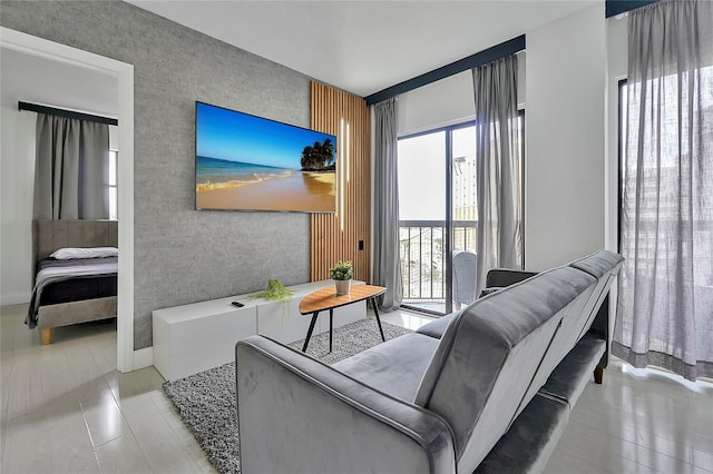 living area with an accent wall and baseboards