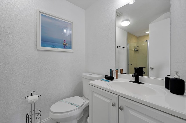 bathroom with toilet, a stall shower, vanity, and a textured wall